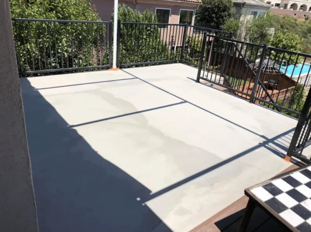 Coated balcony deck with scored joints