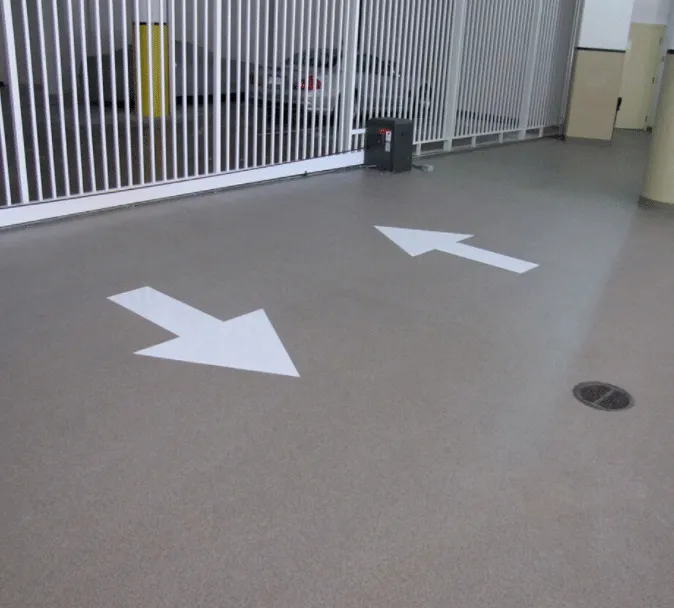 Concrete floor with painted directional arrows