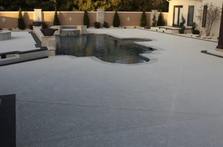 Concrete pool deck around a freeform pool