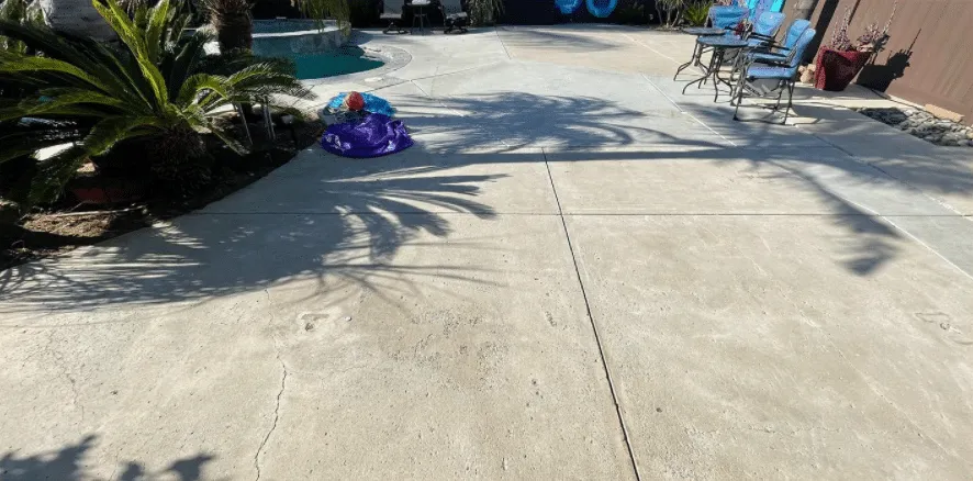 Concrete pool deck with patio furniture