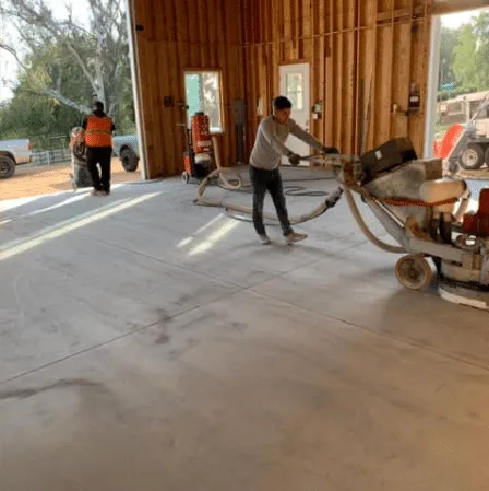 Crew operating a large floor grinder
