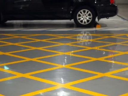 Gray floor with yellow hatched safety striping