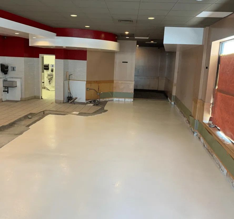 Light coated floor in a commercial interior with red trim