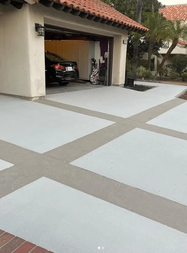 Light concrete driveway with tan decorative bands
