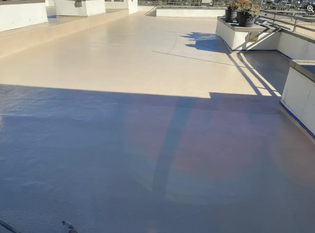 Light gray coated deck surface on a building terrace