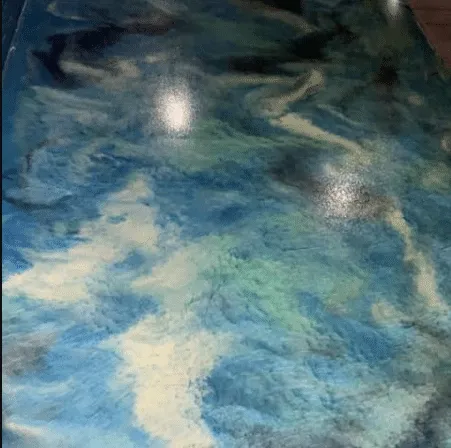 Blue and white metallic epoxy floor with a marbled, high-gloss finish