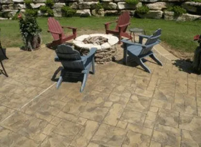 Stone-pattern concrete patio with a fire pit