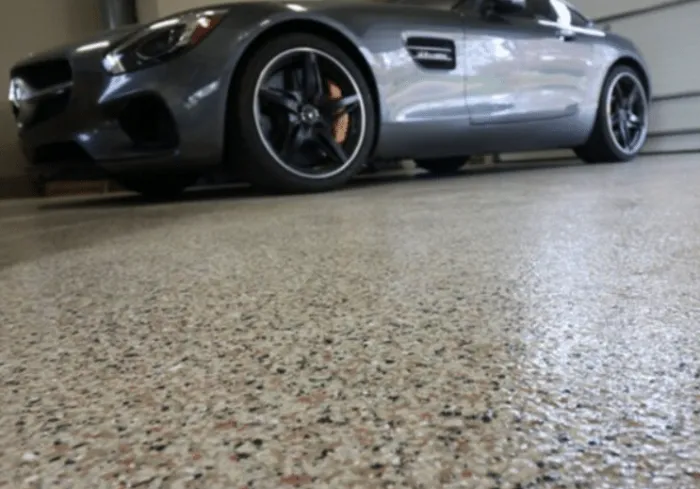 Car parked on a flake-finish garage floor